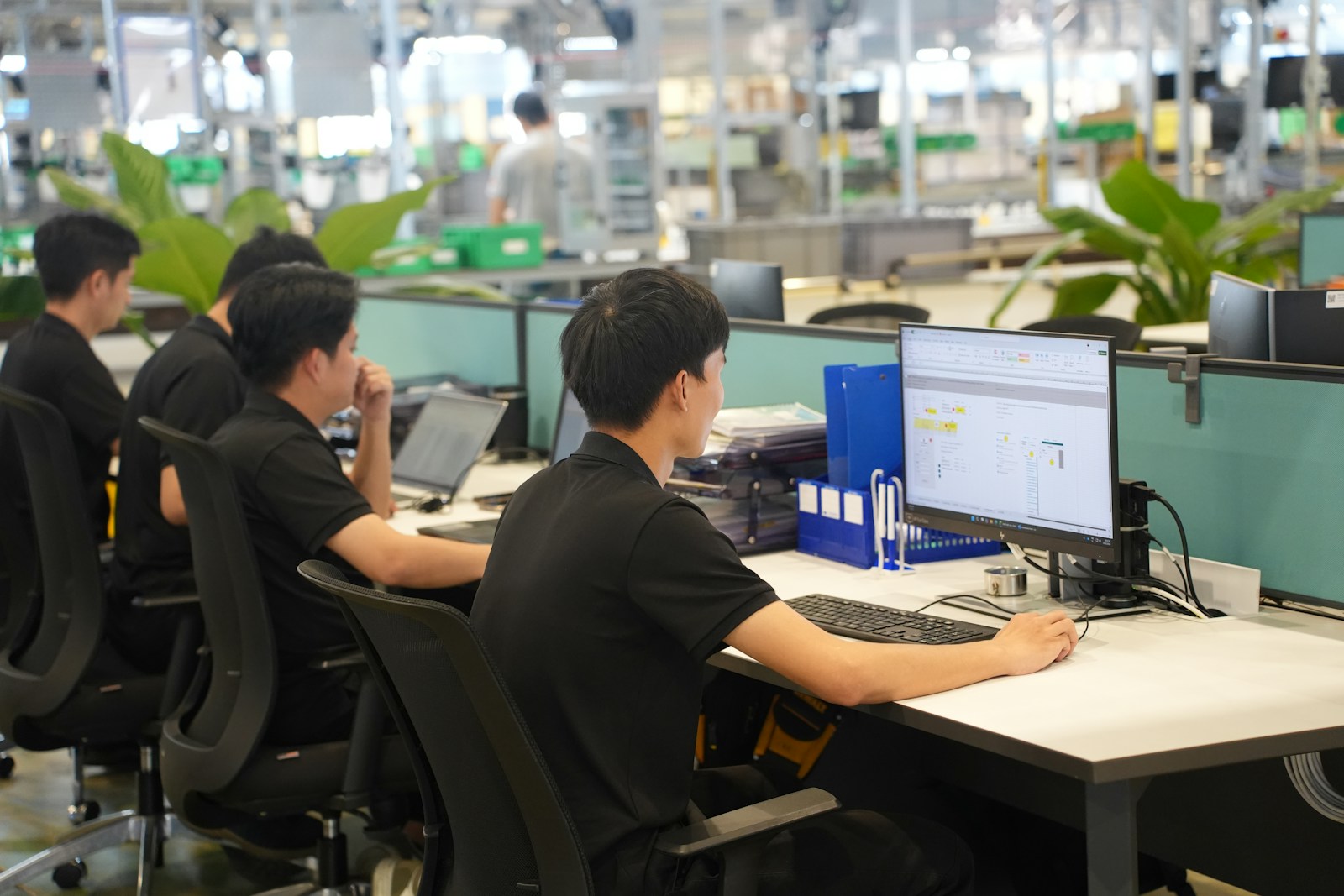 Workers at computers in a modern office setting