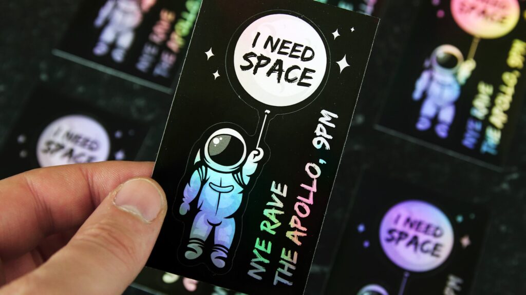 a hand holding a black and white video game case