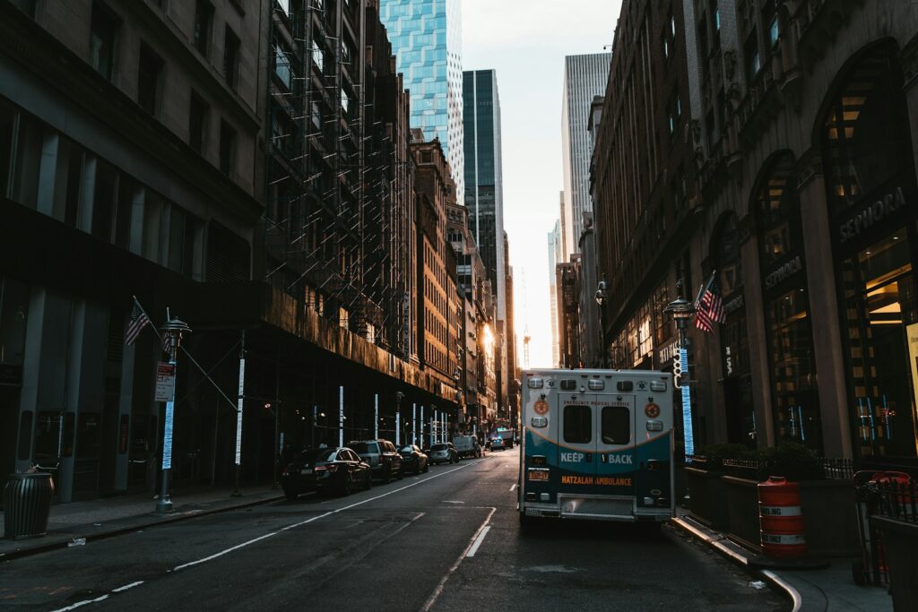 When AI Enters Healthcare, the Poor Pay the Highest Price a truck driving down a street next to tall buildings