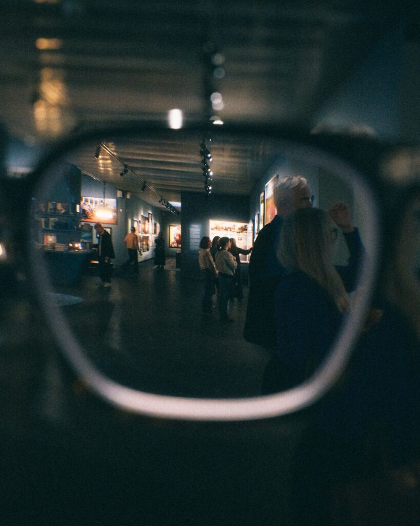 People viewing art in a museum through glasses