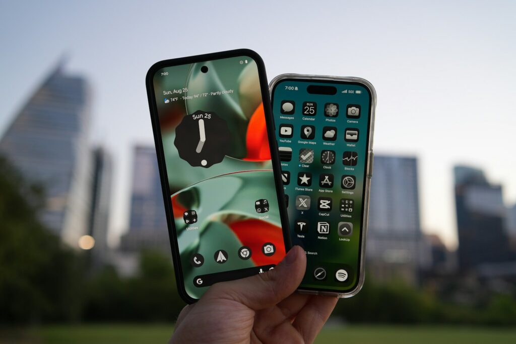 Two smartphones held up against city skyline