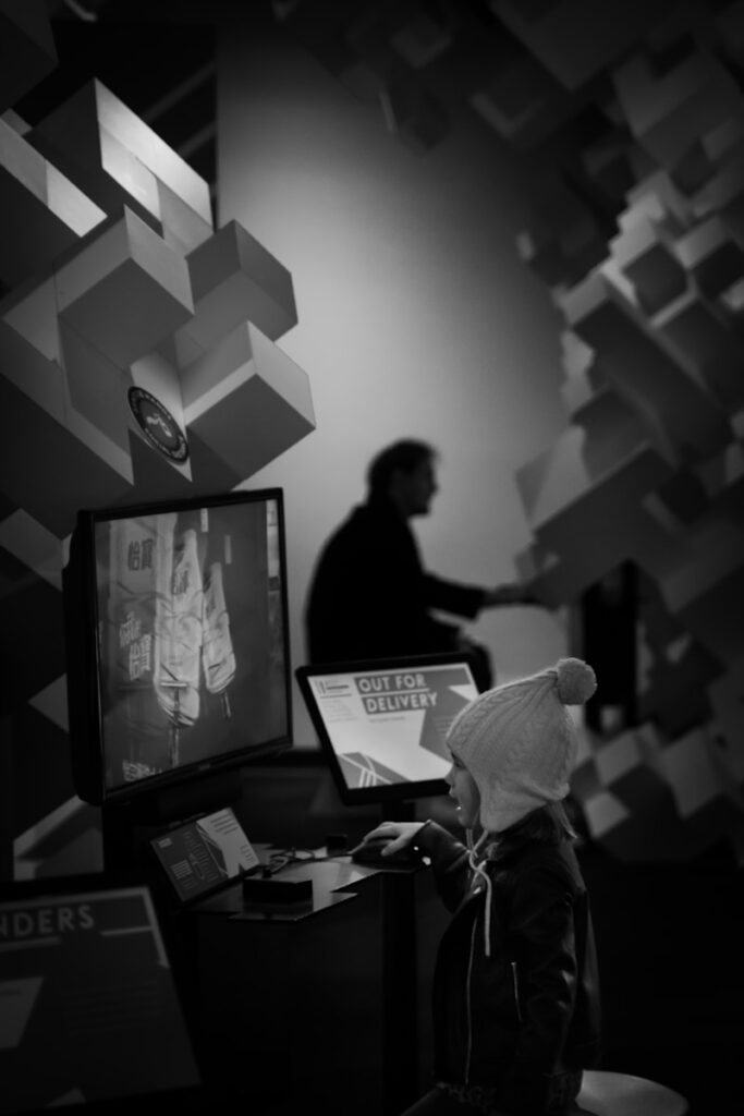Child interacting with interactive display at museum exhibit