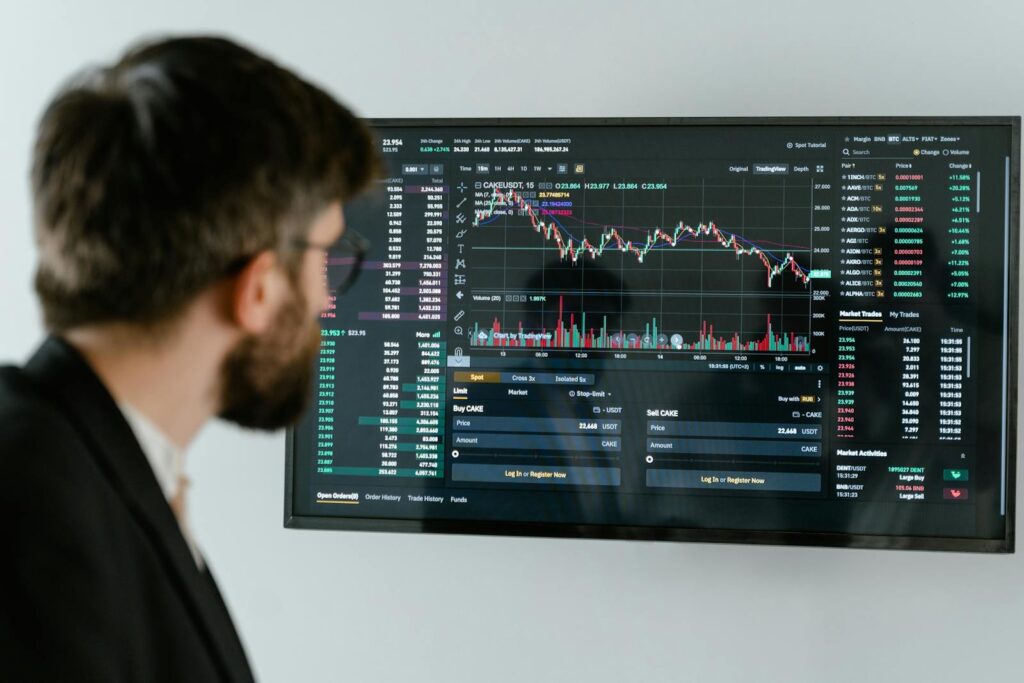 The New AI Shockwave That Crashed Software Stocks Overnight A businessman in a suit looks at a screen displaying stock market charts and data analysis.