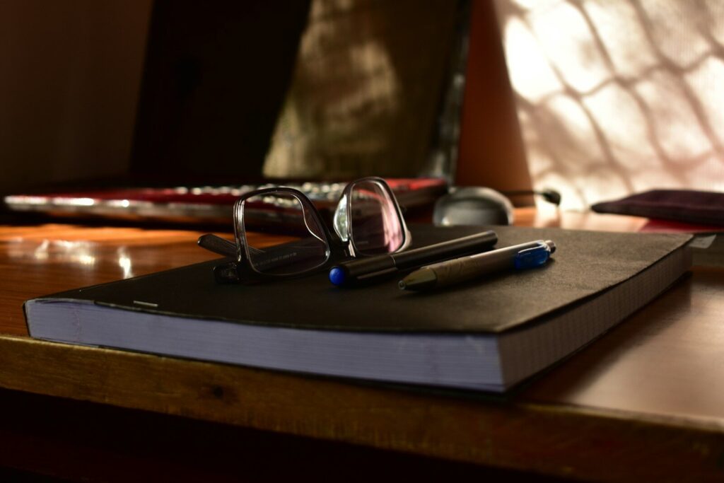 Why A.I. Literacy Becoming New Most Important Skill in Schools Glasses and pens on a notebook