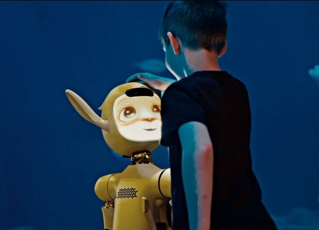 How AI Is Quietly Rewriting the New World Faster A young boy gently pats a yellow robot