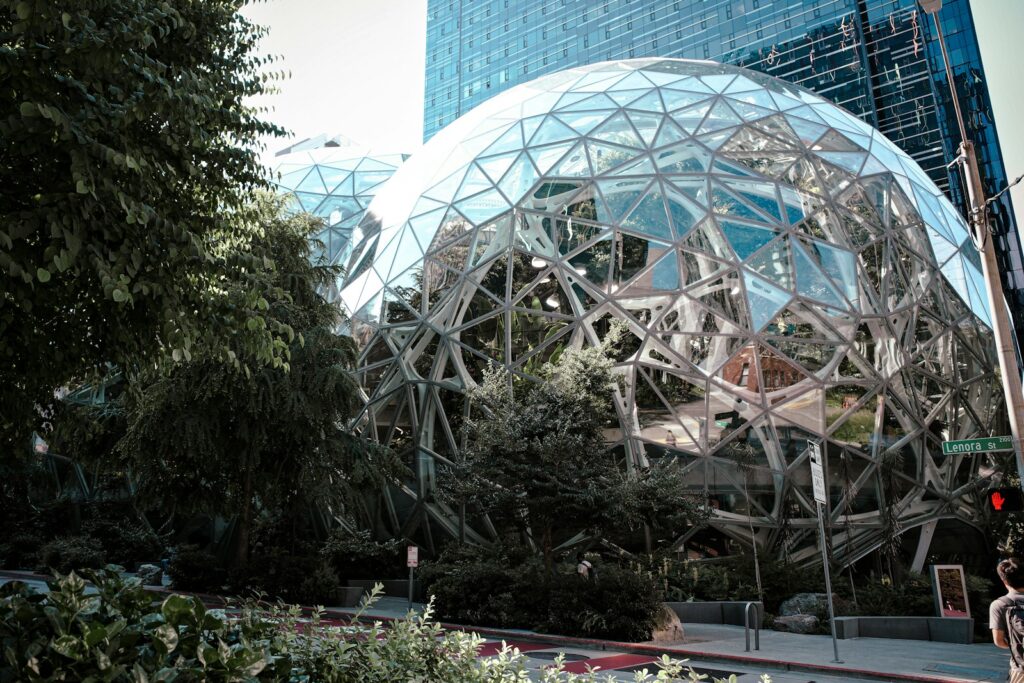 Amazon’s $200 Billion AI That Reshape the New Global Economy Modern glass spheres building with lush green trees