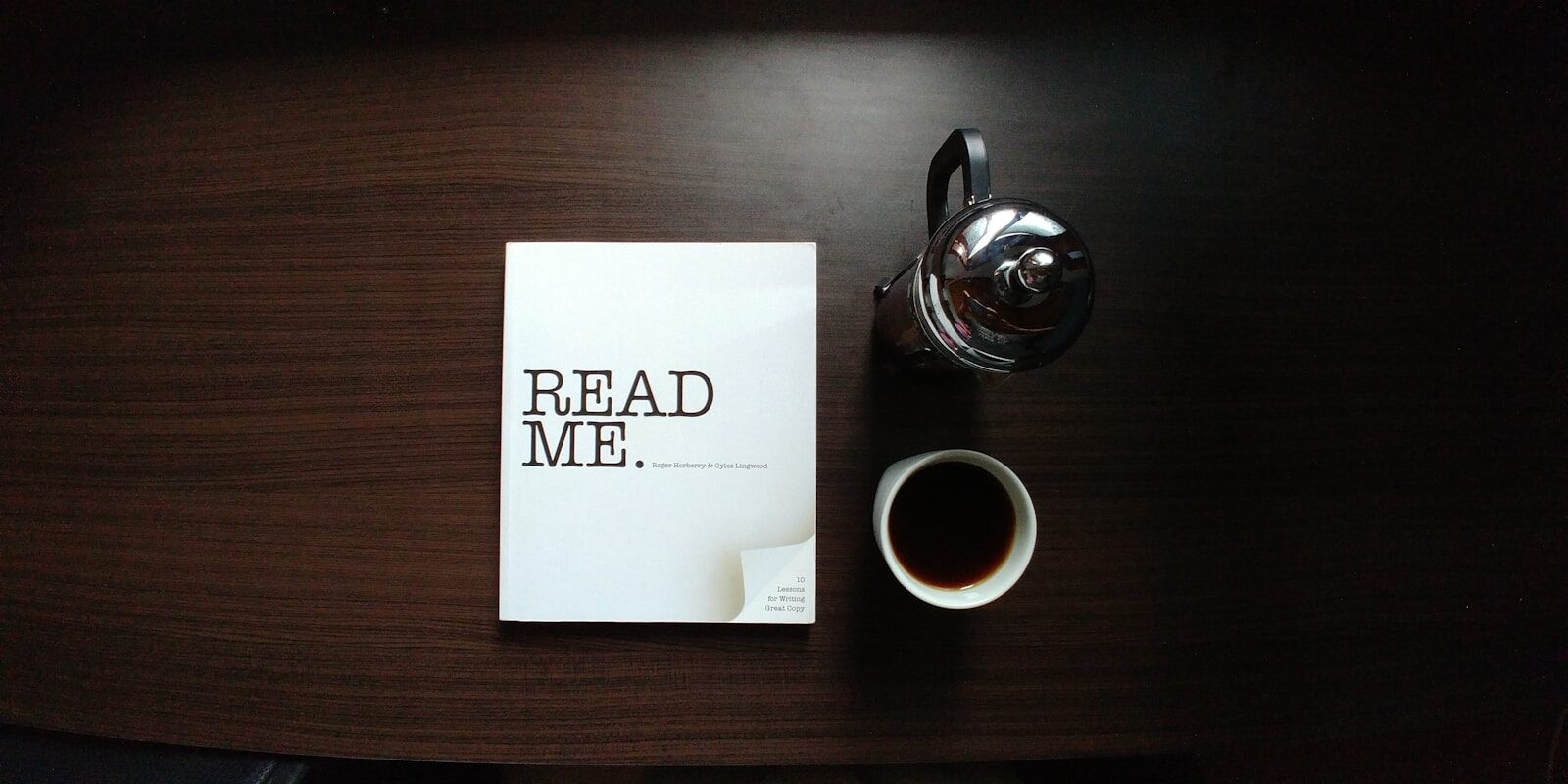How AI Is Learning to Decode New Human Thoughts flat-lay photo of Read Me. book beside cup and silver mug on table
