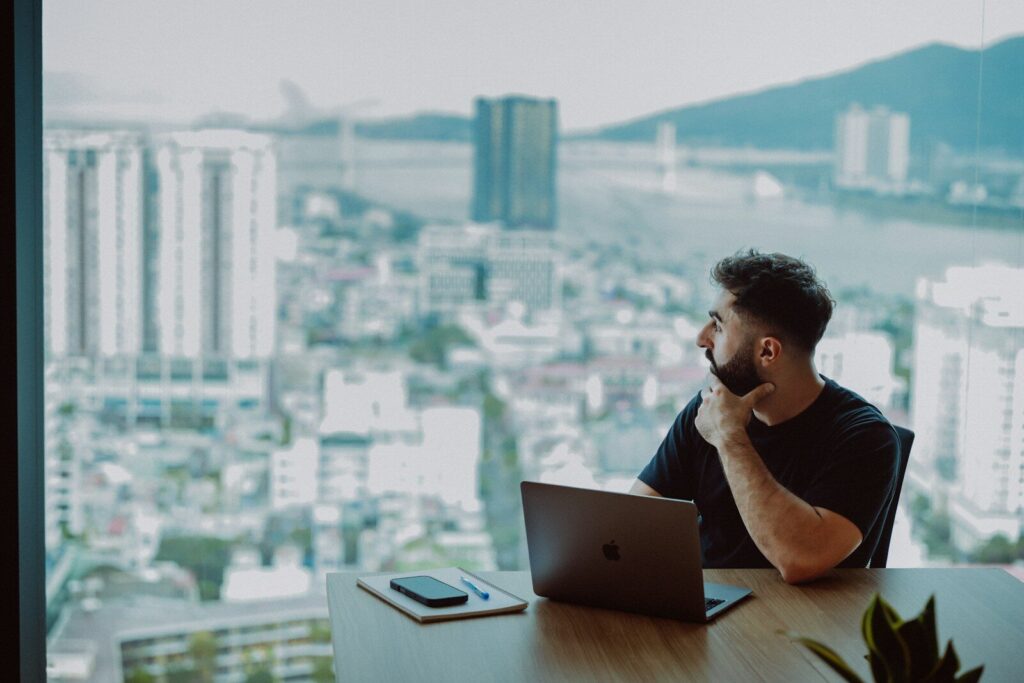 What’s Left for Humans in the New Age of AI? Man looking out window at city skyline