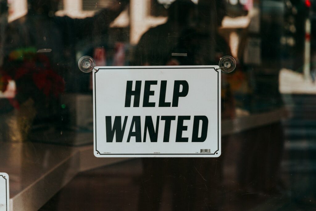 Why Tech Industry’s Fastest Revolution Is Meeting New Resistance a sign that says help wanted on a glass door