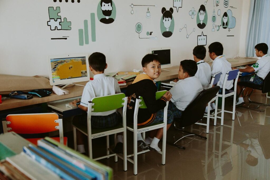 Elementary school students learning in a tech-driven, modern classroom setting.
