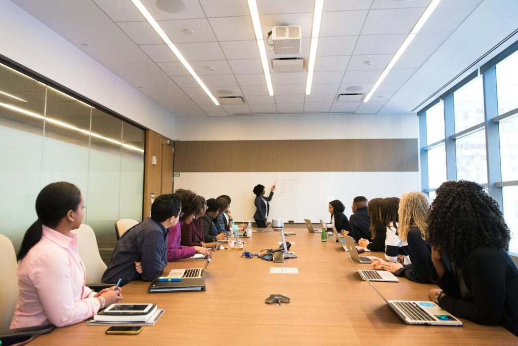 The Best Courses That Can Turn Beginners into Entrepreneurs Business meeting with diverse team discussing projects in a modern conference room.