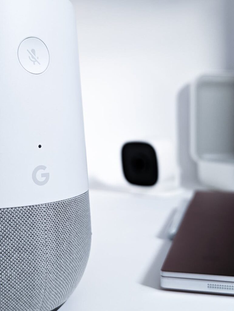 How AI Is Redefining What Humans Expect From New Technology Close-up of a smart speaker on a desk with modern gadgets in a sleek setting.