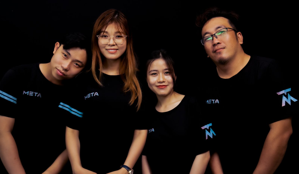 Four diverse young adults in META logo T-shirts against a black background.