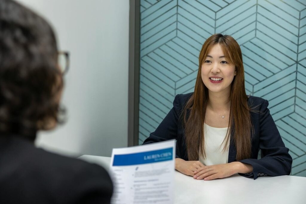 AI Will Reshape New Jobs Not Just Replace Them Young woman in a business meeting with an interviewer, showcasing confidence and professionalism.