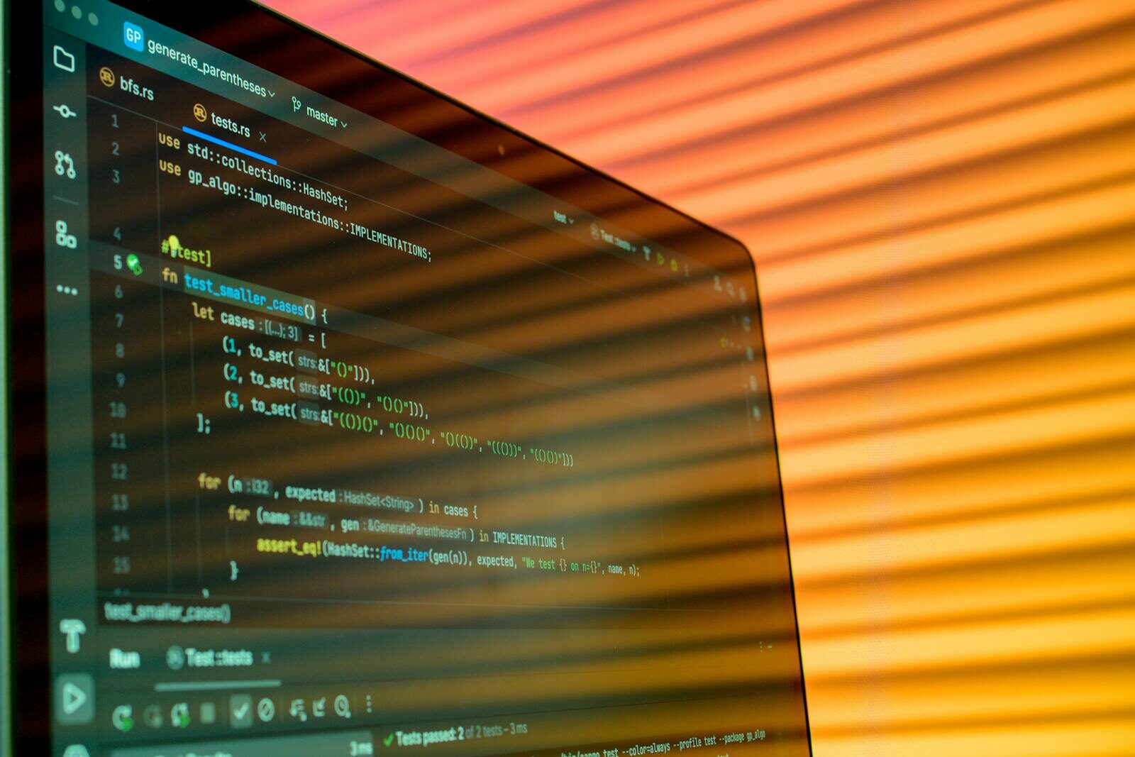 How Rivalries Between Tech Titans Are Defining New Future Intelligence Blurry close-up of a computer screen displaying code with orange lighting.
