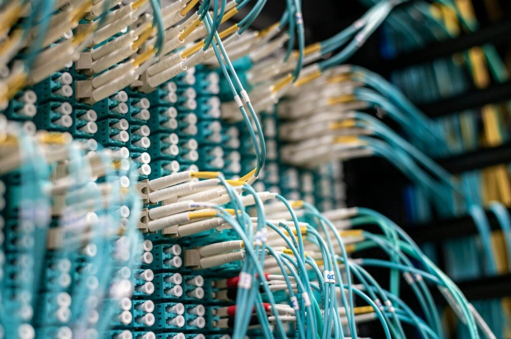 Detailed view of fiber optic cables connected to a patch panel in a data center.