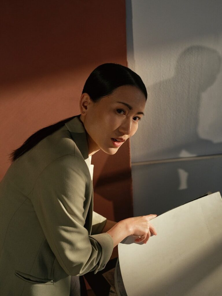 A woman in a suit looking at a document