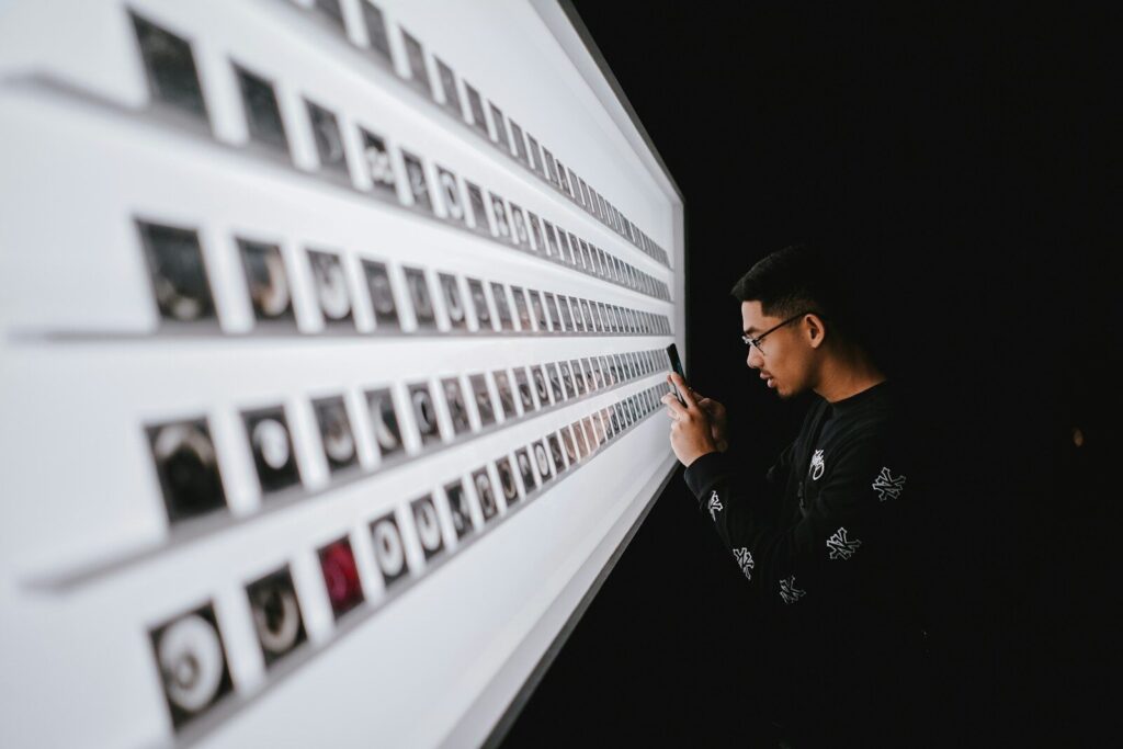 standing man while using smartphone