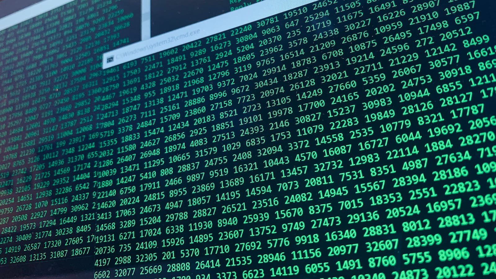 Vibrant green numbers on a computer screen, showcasing binary code and data streams.