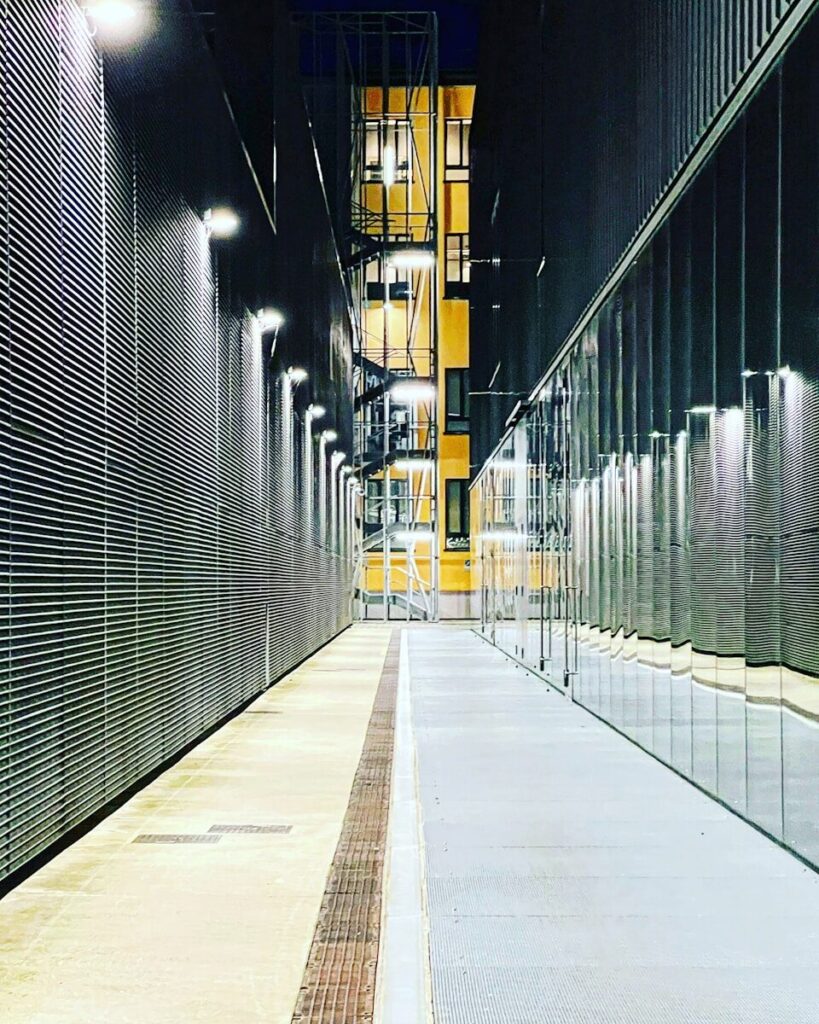 a long hallway with a clock on the side of it