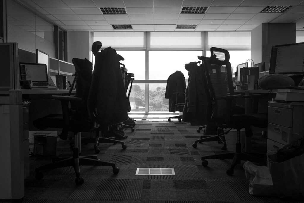 a room with a desk and chairs