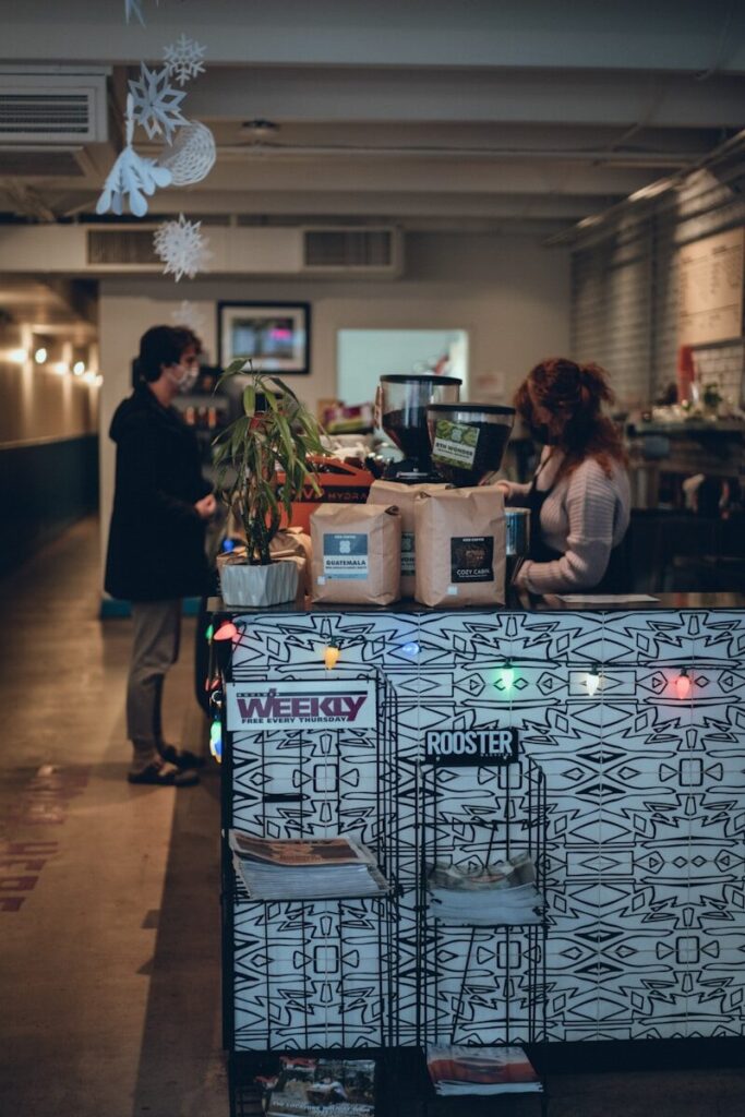 a couple of people standing at a counter