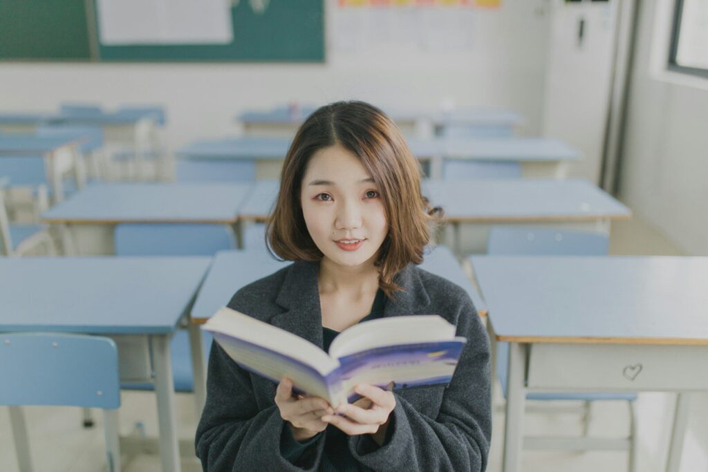 Why Schools Are Turning to New AI to Support Students woman reading book sitting on chair in room