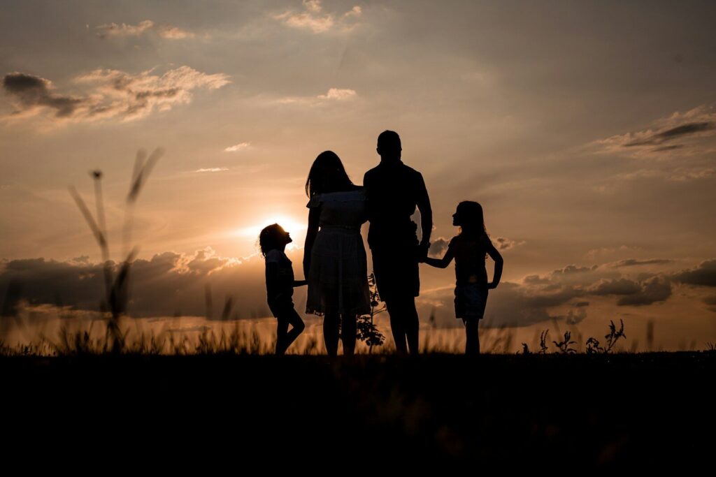 The Neuroscience-Backed New Blueprint That Every Parent Needs Today a family standing in a field at sunset