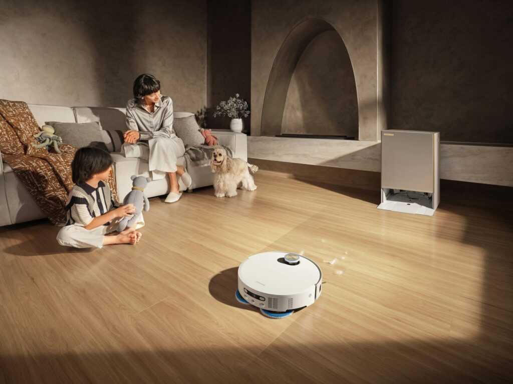 Robot vacuum cleans floor while family relaxes