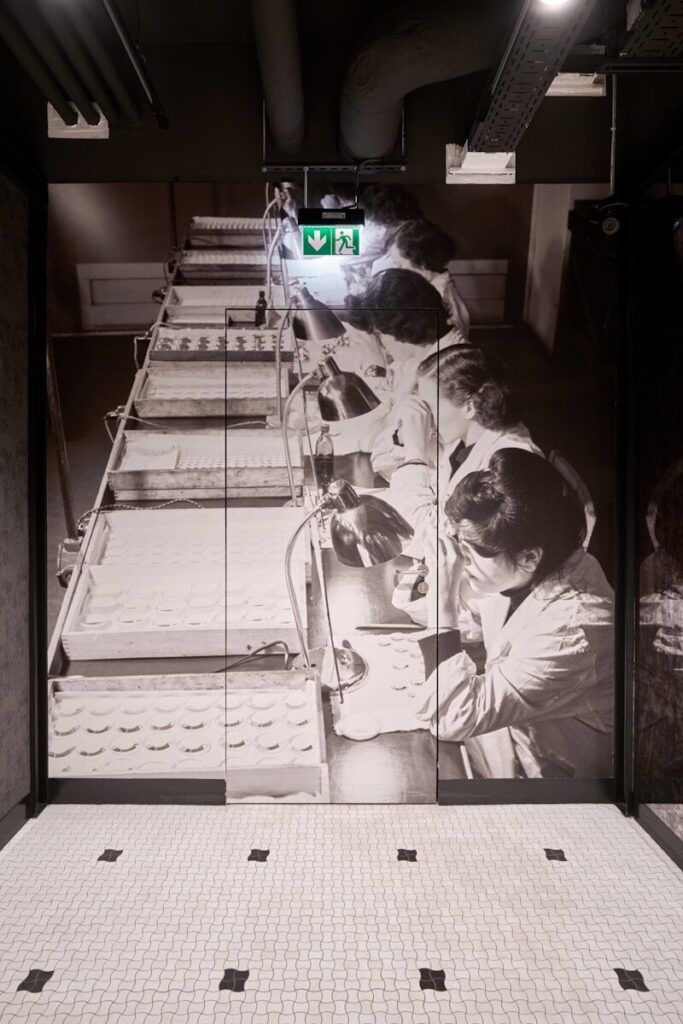 a group of people sitting on a bench in a room