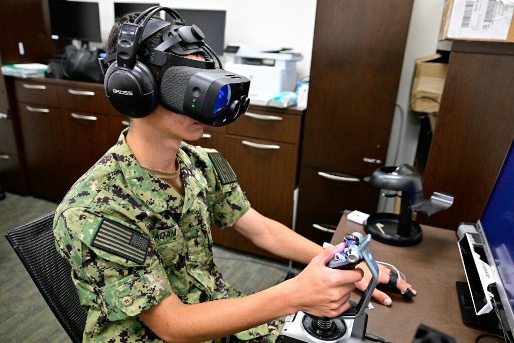 How Technology Powering New Digital Battlefield in the Persian Gulf Sailor uses virtual reality headset and joystick