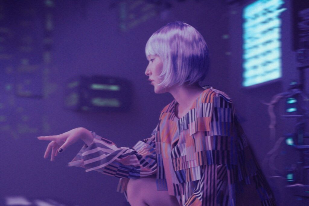 a woman in a colorful dress standing in a room