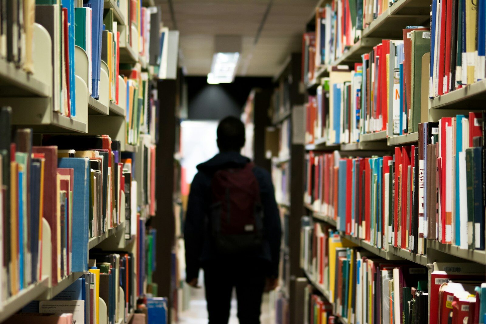 Why New York’s Bold High School Plan Was Suddenly Halted man with backpack beside a books