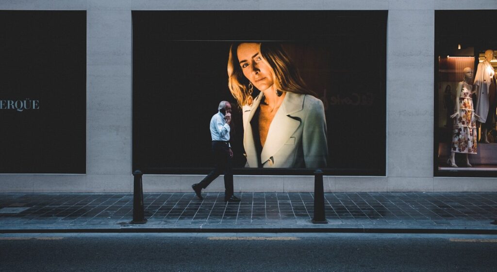 person walking near poster