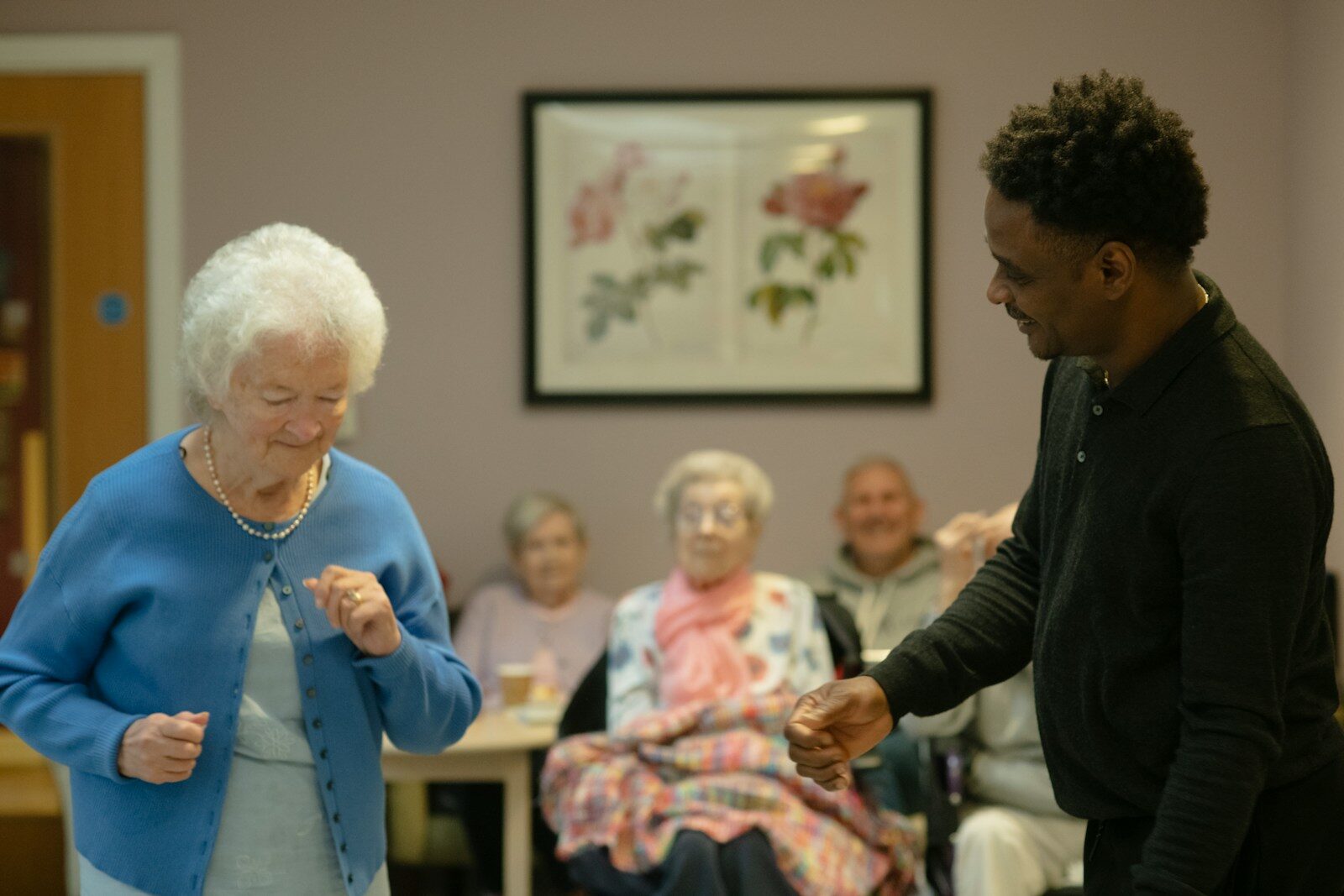 The New AI Robot Transforming Senior Care and Human Aging Elderly woman dancing with a man in a room.