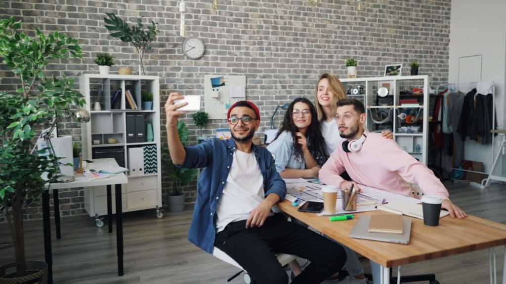 a group of people sitting around a wooden table