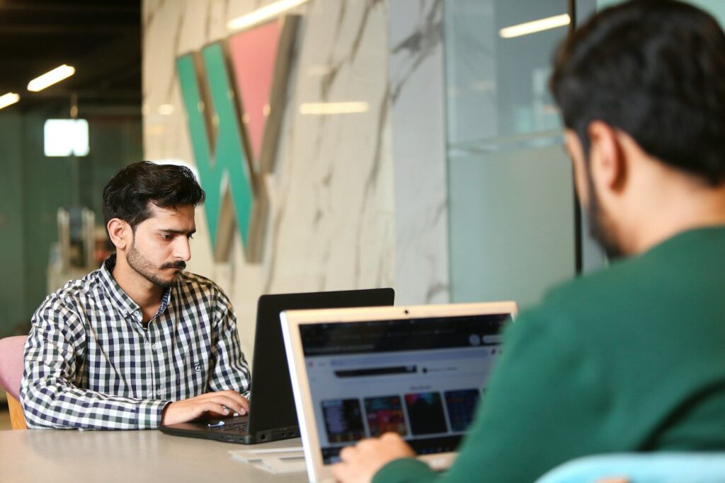 a man sitting in front of a laptop computer