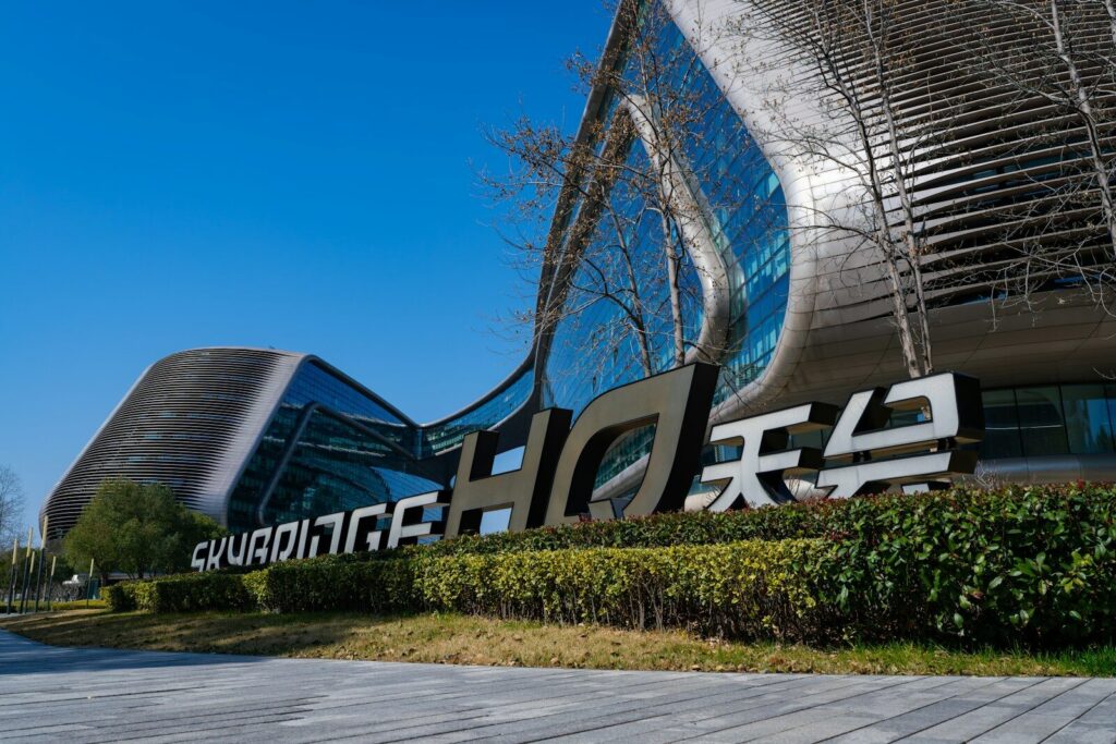 China’s New Brain Drain Is Reshaping the Global AI Race Modern architecture with a large sign in front