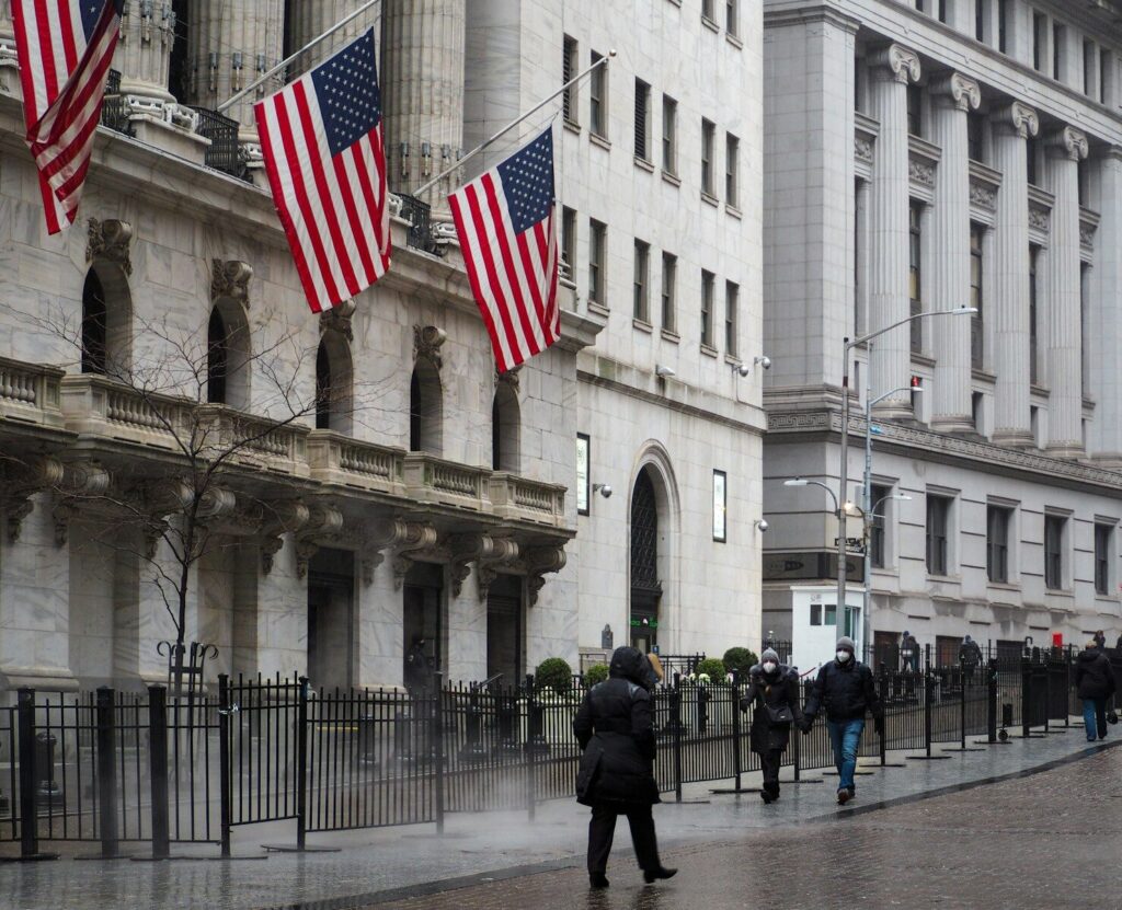 Trump’s New AI Order Signals Major Shift America’s Tech Strategy a group of people walking down a street next to tall buildings