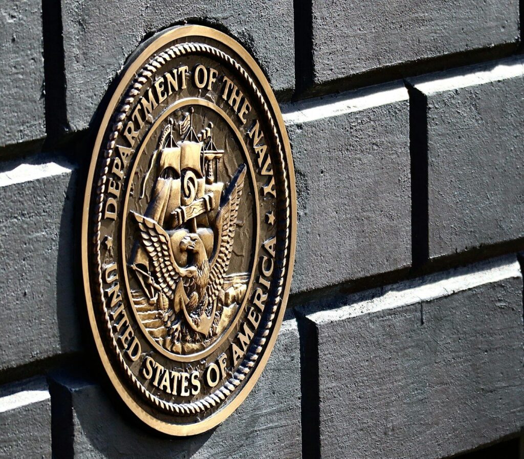 the seal of the department of the navy on the side of a building