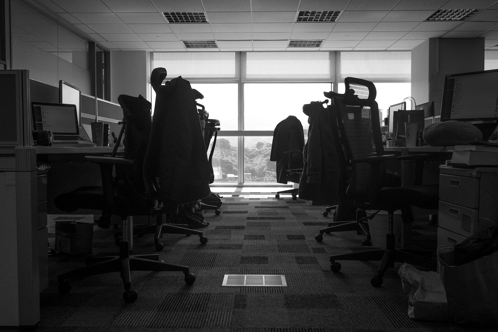 a room with a desk and chairs