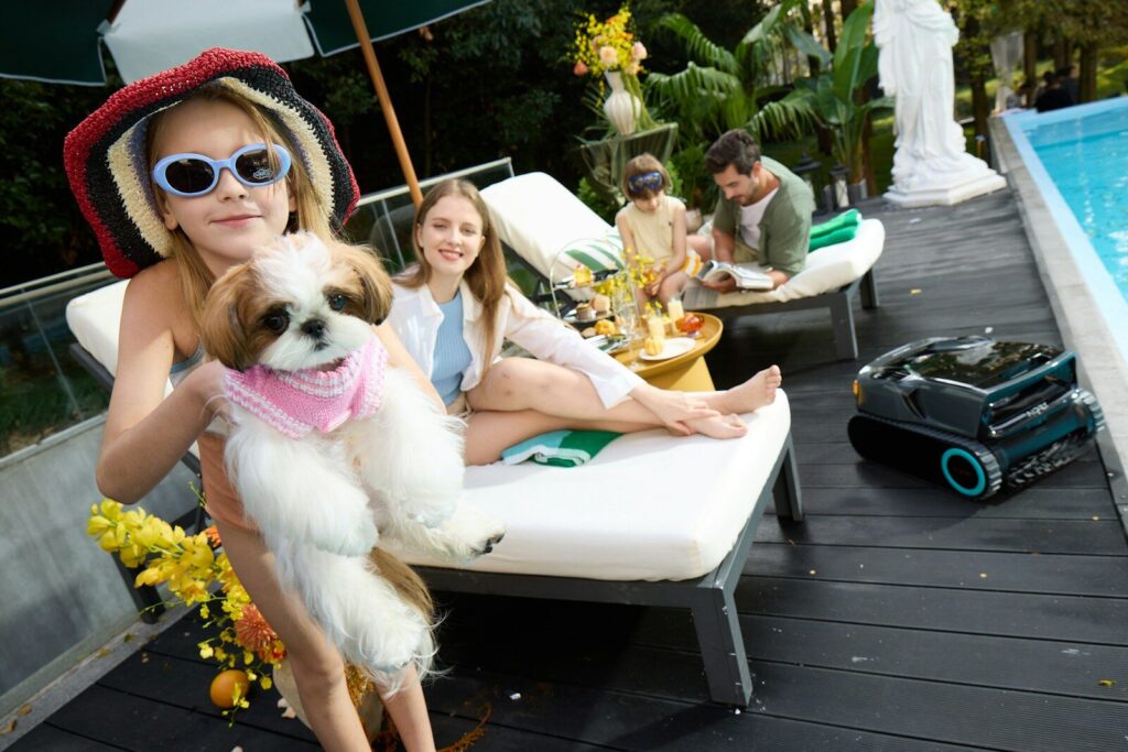 Family relaxing by the pool on a sunny day.