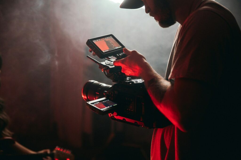The $500,000 New AI Movie That Shocked Cannes man in white t-shirt holding black video camera