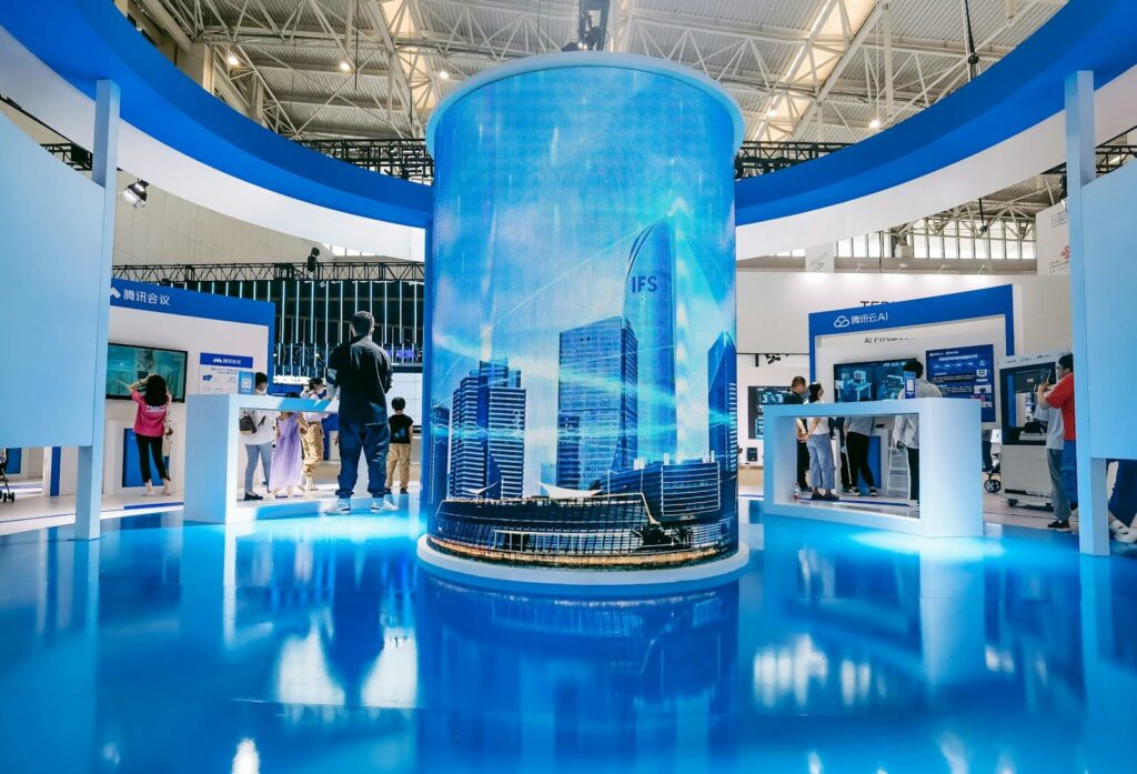AI Is the Biggest New Tech “Tsunami” Ever, Says John Doerr people standing in front of blue and white building