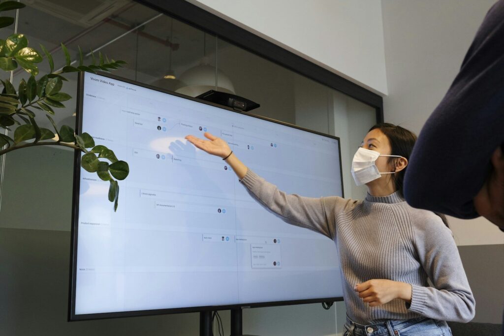 Microsoft AI Chief Just Issued New 18-Month Warning White-Collar Workers man in white and black checked dress shirt holding white printer paper