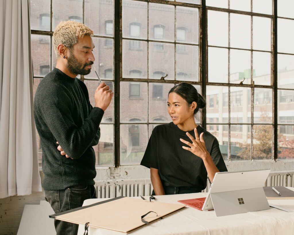 Microsoft’s New Responsible AI Push Growing Fear Inside Big Tech a man standing next to a woman at a table