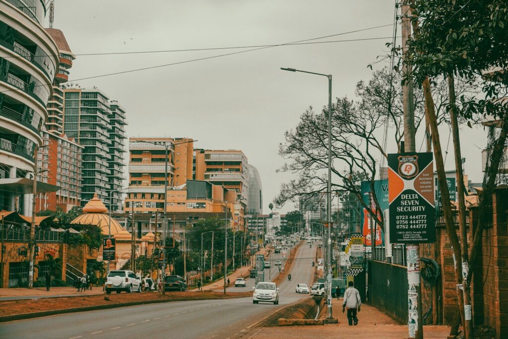 How Kenya’s Digital Health Revolution Is Pricing Out the Poor a man walking down a street next to tall buildings