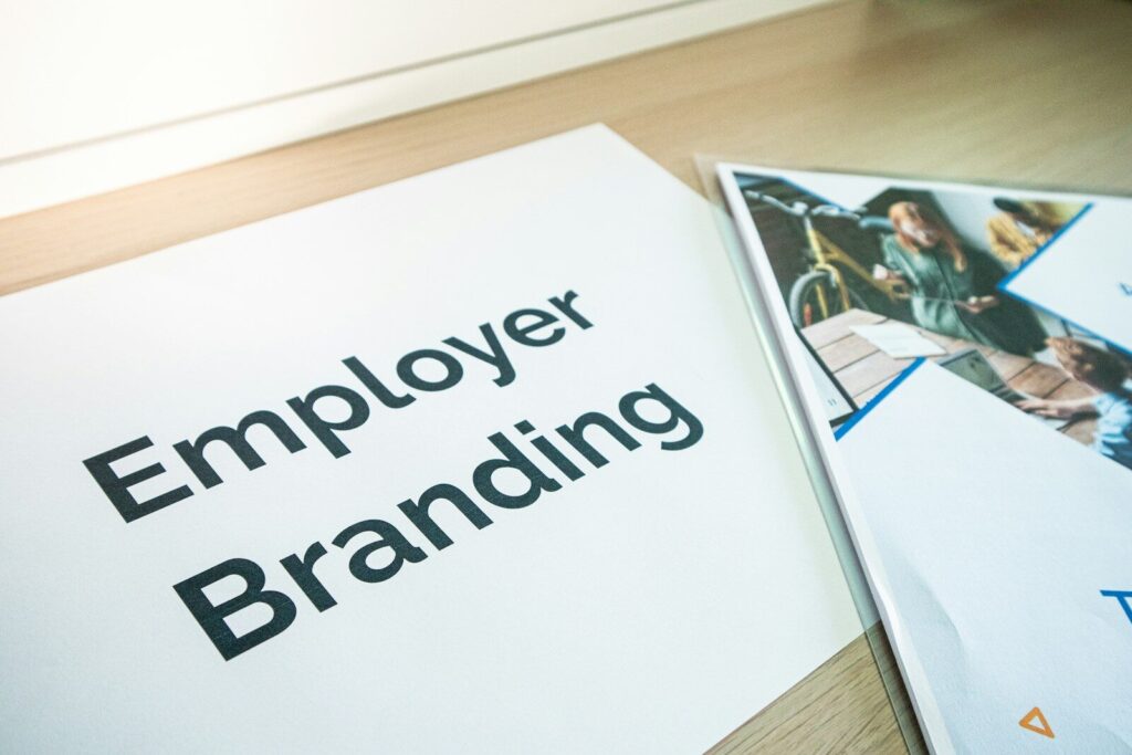 Why Tech Giants Cutting Jobs While Spending Billions New AI an employee branding brochure on a table