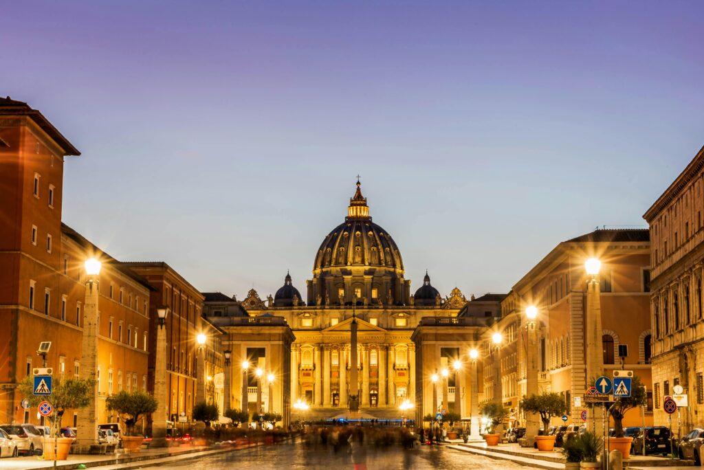 The Vatican Is New Warning About The Soul We Lose Along the Way. Dramatic view of St. Peter's Basilica illuminated at twilight in Rome.