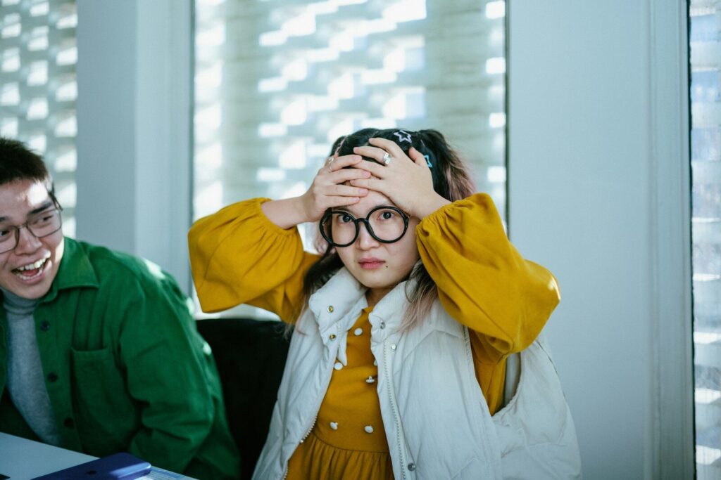 Inside Quiet Relationship Crisis Emerging in the Shadow of AI a boy and a girl sitting at a table with a laptop